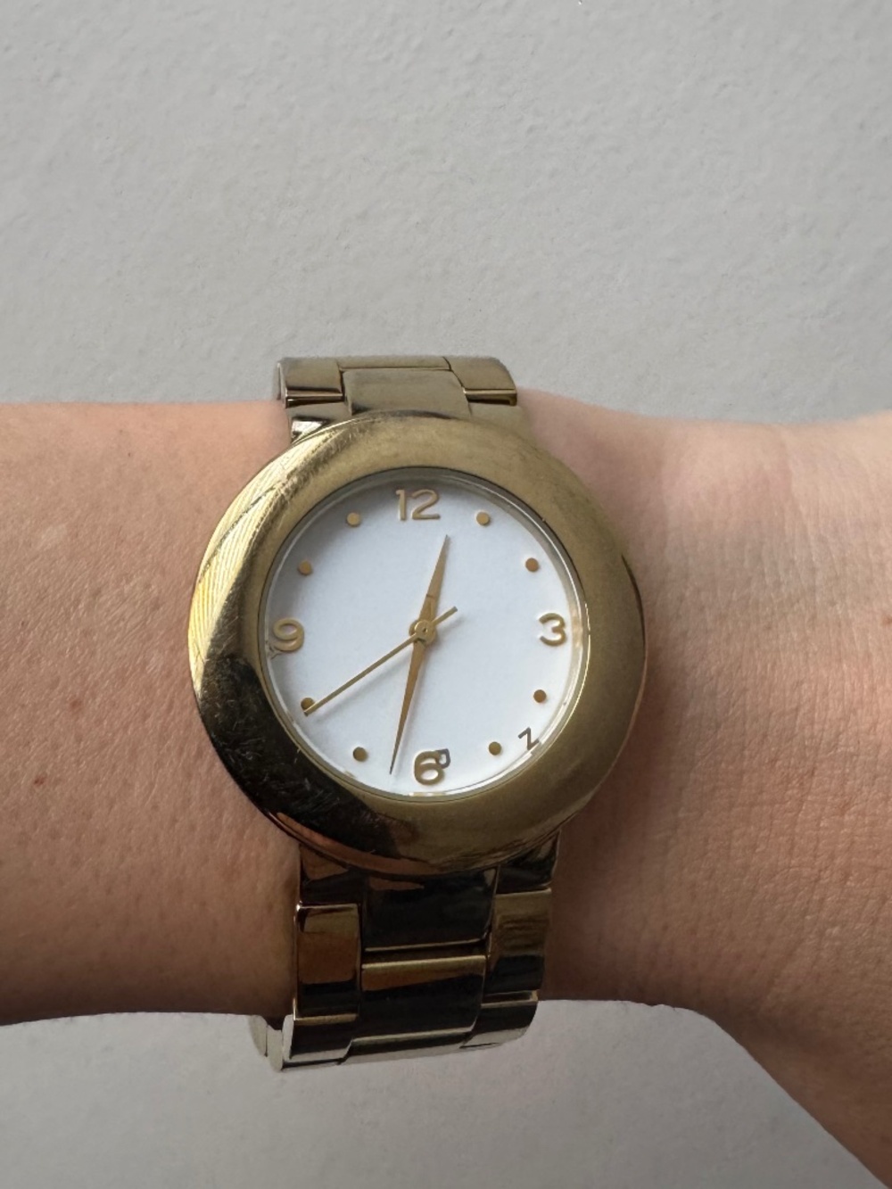 DKNY watch with gold tone bracelet and white dial